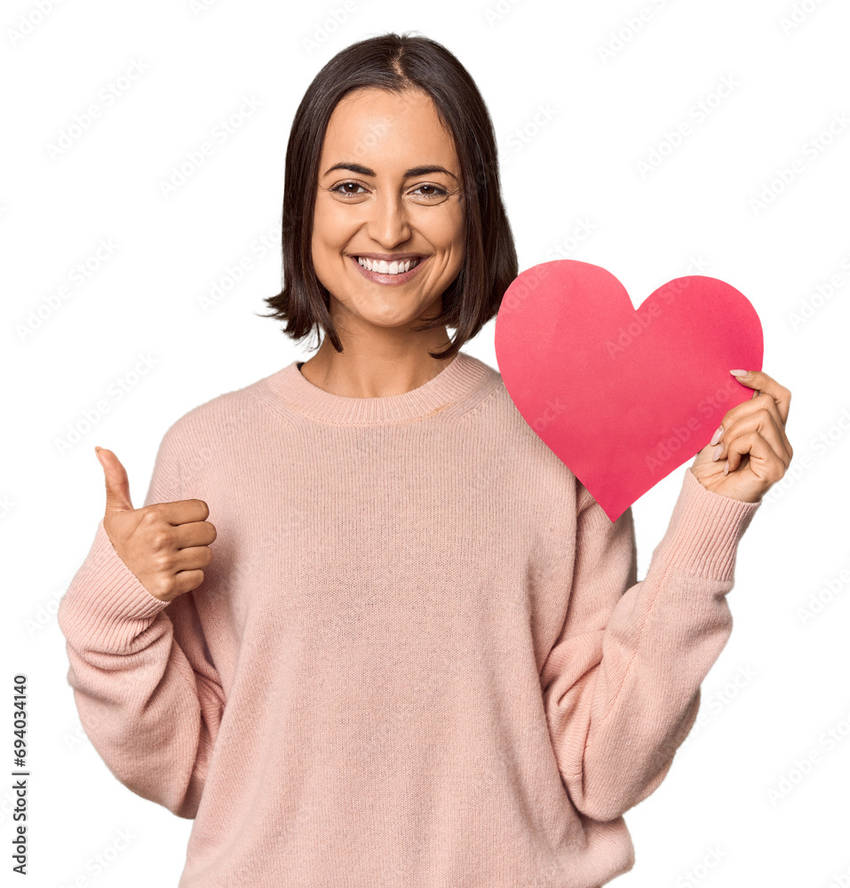 Young woman holding Valentine's heart smiling and raising thumb up Young woman holding Valentine's heart smiling and raising thumb up