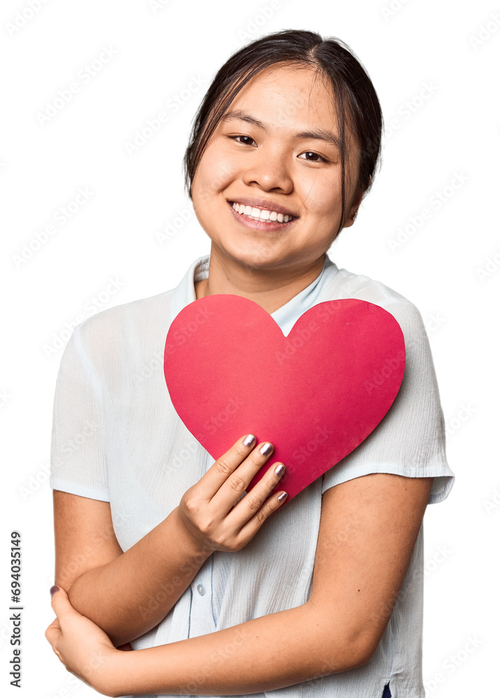 Chinese woman with red Valentine's heart laughing and having fun. Chinese woman with red Valentine's heart laughing and having fun.