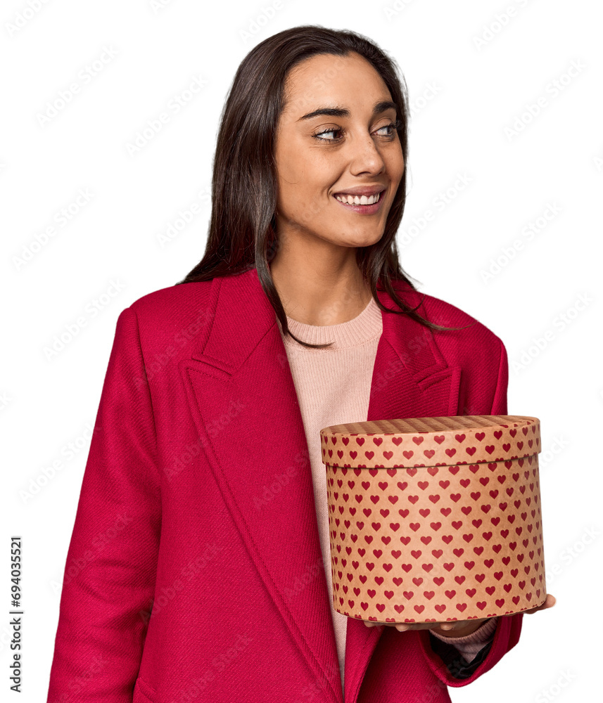 Caucasian woman with Valentine's gift box looks aside smiling, cheerful and pleasant. Caucasian woman with Valentine's gift box looks aside smiling, cheerful and pleasant.