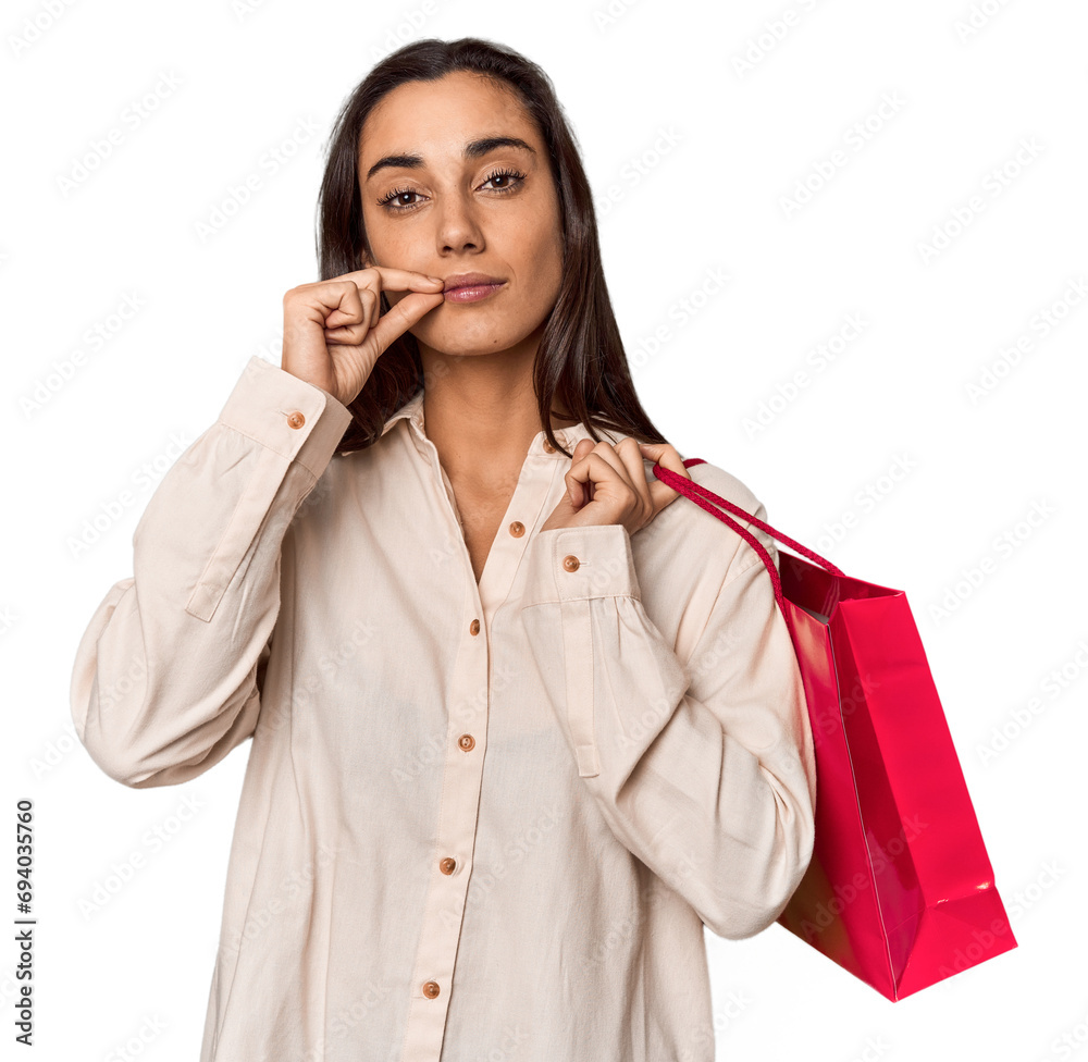 Young woman with Valentine's red bag with fingers on lips keeping a secret. Young woman with Valentine's red bag with fingers on lips keeping a secret.