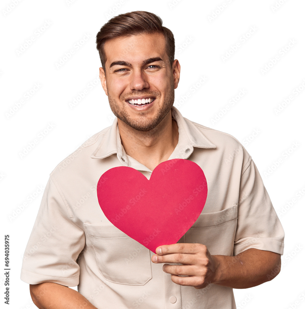 Young man holding a heart laughing and having fun. Young man holding a heart laughing and having fun.