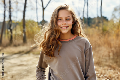portrait of a blond haired smiling girl in the nature