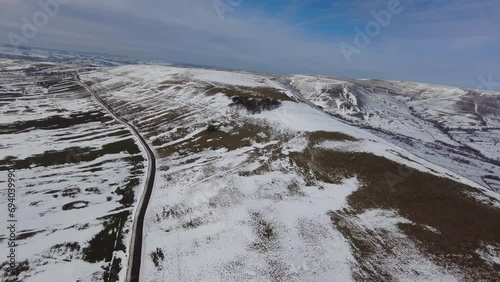 Helicopter view of paragliders below winter landscape ice cold flying fun pleasure remote rural hills fields photo