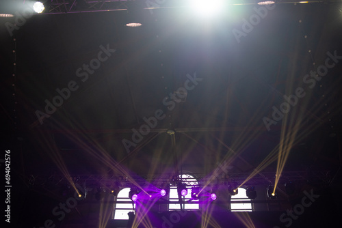 concert stage. bright colorful lighting beams on dark background