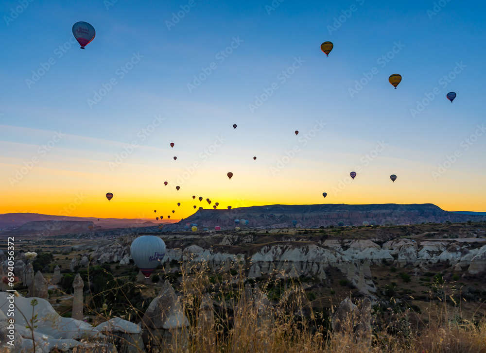 Hot Air Balloons Over Love Valley in Cappadocia, Turkey At Sunrise. 
