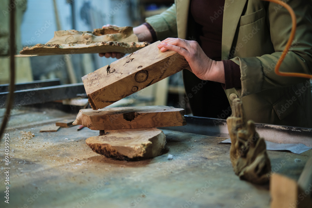 A collection of burl wood, rich with knotted details and organic contours, is poised for crafting, embodying the rustic elegance of woodworking. A collection of burl wood, rich with knotted details and organic contours, is poised for crafting, embodying the rustic elegance of woodworking.