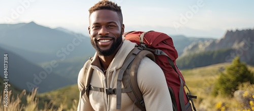Black man hiking in nature for fitness, health, and adventure.