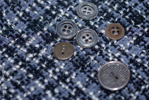 sewing accessories,old metal buttons on fabric.
