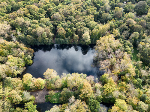 Aerial photo of the Segmeertje pond in the Meer en Bos park in The Hague with autumn coloured trees.