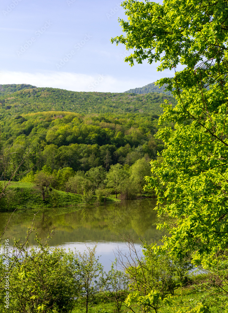 mountainous terrain, natural lakes in the morning light, spring nature walks, panorama of the area.