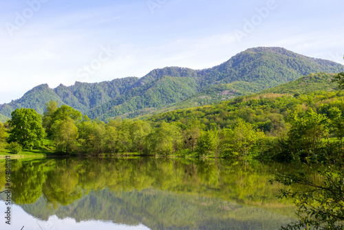 mountainous terrain, natural lakes in the morning light, spring nature walks, panorama of the area.