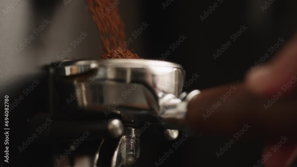 Slow motion closeup of fresh ground coffee fall in portafilter Slow motion closeup of fresh ground coffee fall in portafilter