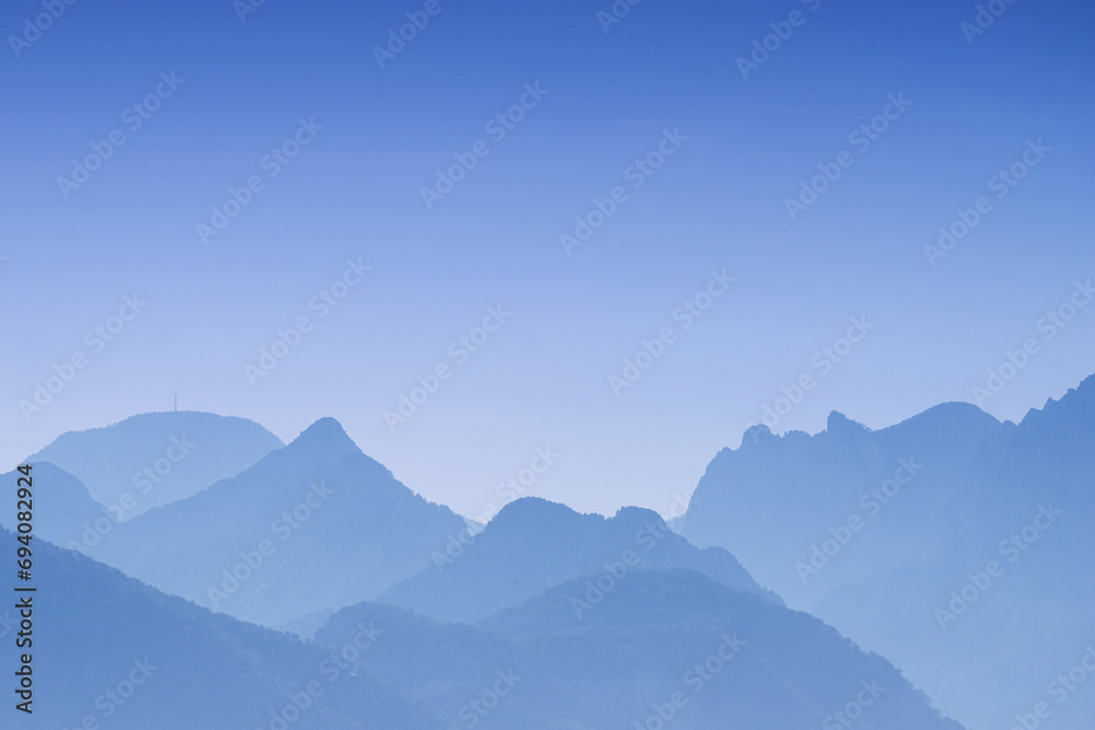 Abstract blue mountains and colorful sky - turquoise sunset over the landscape - background Abstract blue mountains and colorful sky - turquoise sunset over the landscape - background