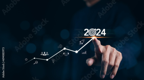 The 2024 new year business goals concept. Businessman touching increase arrow graph company future growth 2024. Business plan target strategy, Planning and challenge business strategy in new year, photo