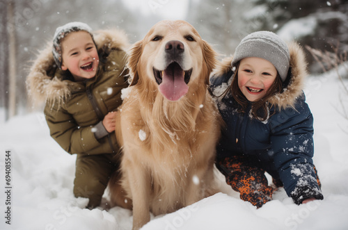 Golden retriever playing with kids in the snow.
