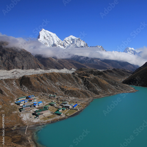 Gokyo, turquoise lake Dudh Pokhari and Cholatse, Nepal. photo