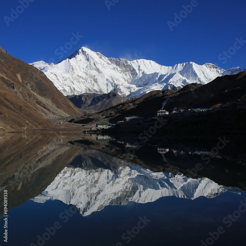 Snow covered mountain Cho Oyo reflecting on lake Dudh Pokhari, Gokyo. © u.perreten