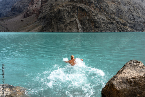 A tourist swims in the mountains of Tajikistan.
