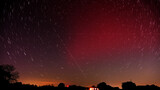 Long exposure of a Stable Auroral Red arc, or SAR arc, a rare space phenomenon over north east Oklahoma sky on November 5th, 2023; with star trails, airplane and satellite tracks crossing the sky