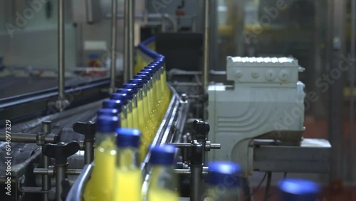 The moment when filled bottles pass through the quality control detector in a fully automated bottling plant, and defective ones are separated