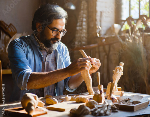 Master old man s hobbyist hands sculpting carving wooden figures sculptures leisure time wood hobby creating by man pure artwork dusty rustic sunny workshop room during artist s creative workflow