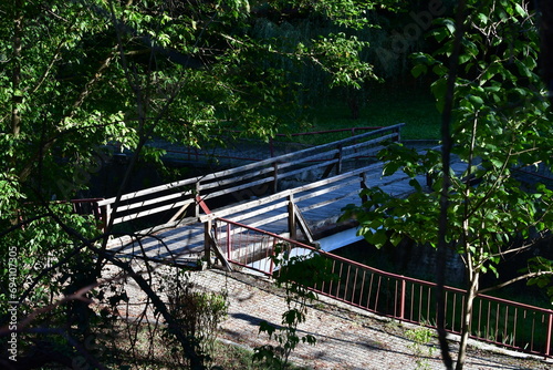 Wooden bridge over the river in the forest.