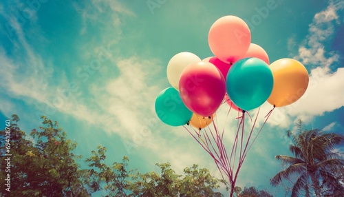 vintage multicolor balloons with done with a retro instagram filter effect on blue sky ideas for the background of love in summer and valentine wedding honeymoon concept