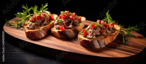 Preparing bruschetta on wood with goose liver.
