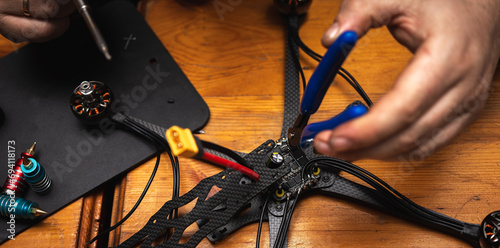 Frame, FPV racing drone frame, assembly, soldering, for the armed forces of Ukraine, installed with tools on the desktop, close-up view