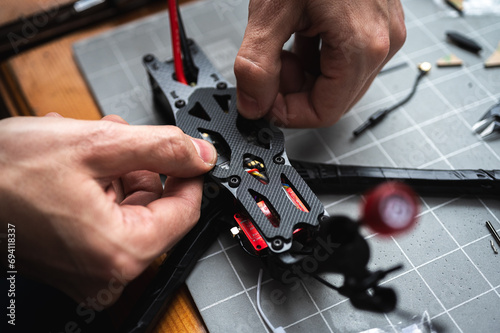 Frame, FPV racing drone frame, assembly, soldering, for the armed forces of Ukraine, installed with tools on the desktop, close-up view