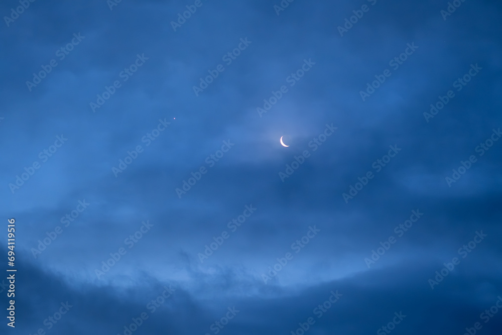 Night sky with old thin bright Moon and star Venus in the clouds, can be used as background. Night sky with old thin bright Moon and star Venus in the clouds, can be used as background.