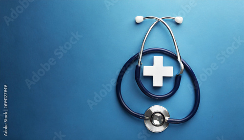Health insurance concept. plus sign with stethoscope on blue background photo