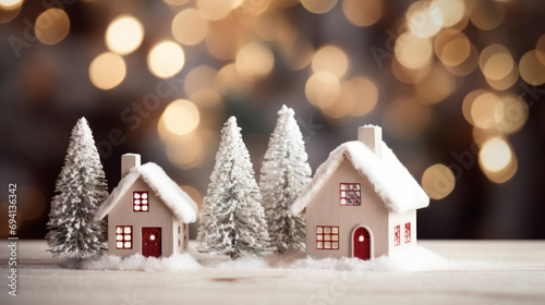 A close-up of a small wooden houses in a snowy setting, conveying the concept of winter discounts on home purchases, New Year sales, and affordable housing options for mortgages. New year decoration.