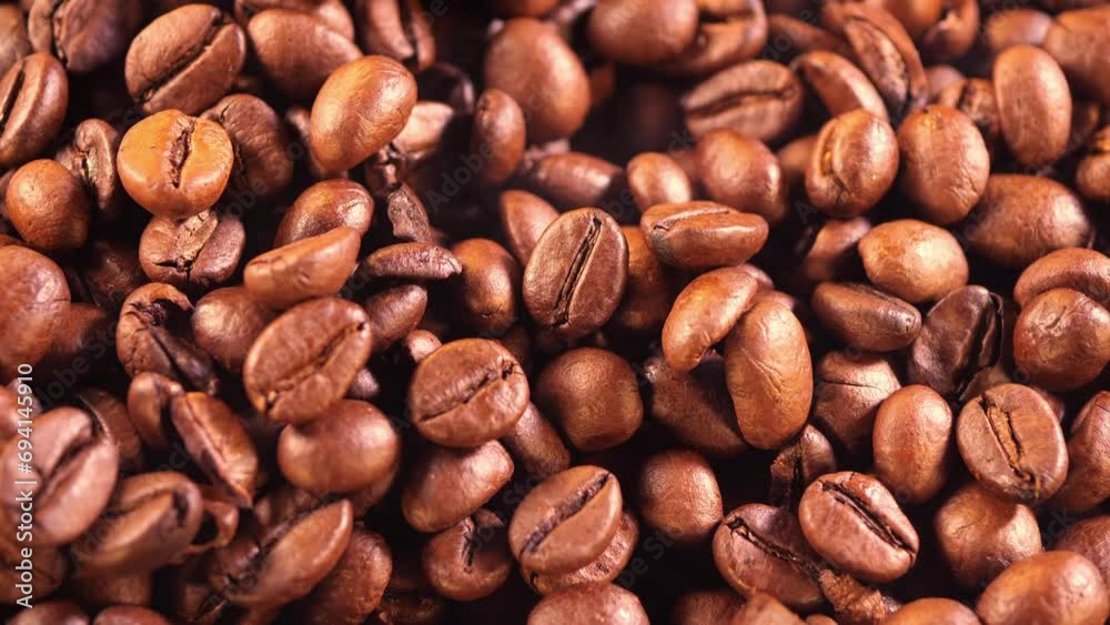 Coffee background. close up of roasted coffee beans with smoke rising and zoom in motion. Harvesting coffee fruits. Roasted beans close-up. Space for your text. Coffee background. close up of roasted coffee beans with smoke rising and zoom in motion. Harvesting coffee fruits. Roasted beans close-up. Space for your text.