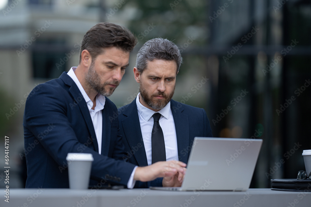 Two successful businessmen smiling at the camera. Handshake business people. two business man. Two business men discussed their strategy. Two successful businessmen smiling at the camera Two successful businessmen smiling at the camera. Handshake business people. two business man. Two business men discussed their strategy. Two successful businessmen smiling at the camera