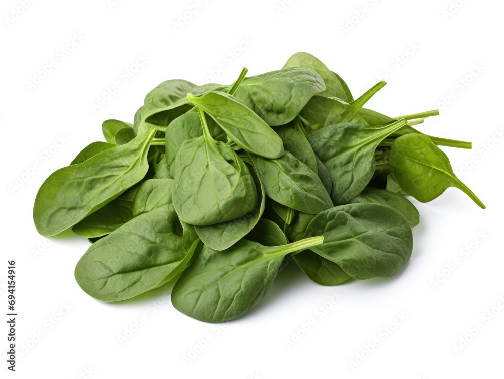 A pile of spinach leaves on a white surface. A pile of spinach leaves on a white surface.