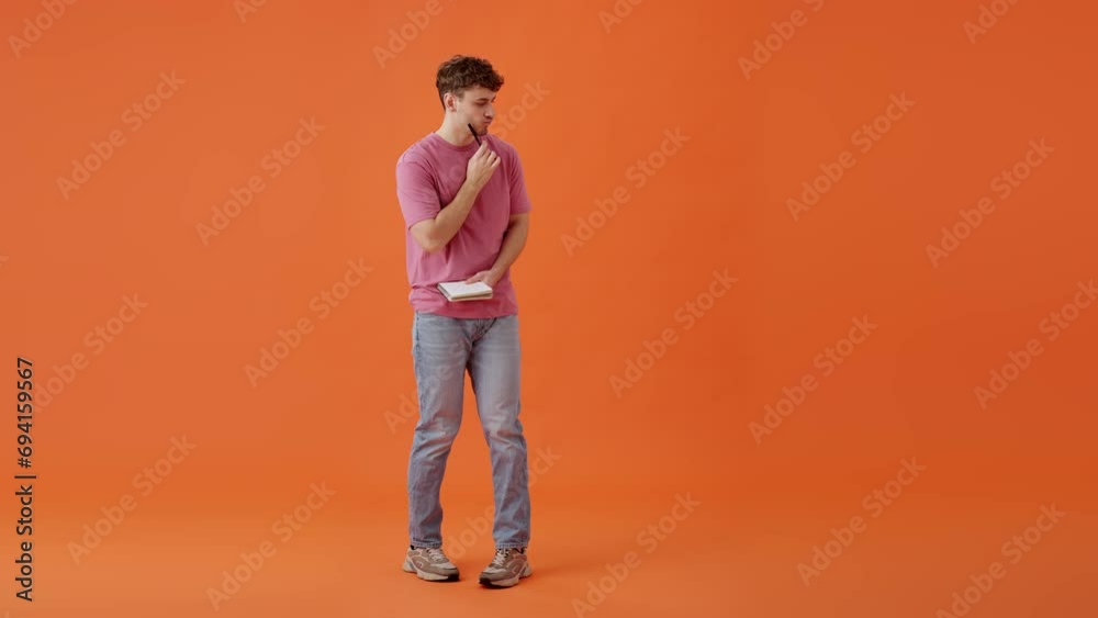 Inspired man writing greay idea in personal notebook indoors Inspired man writing greay idea in personal notebook indoors