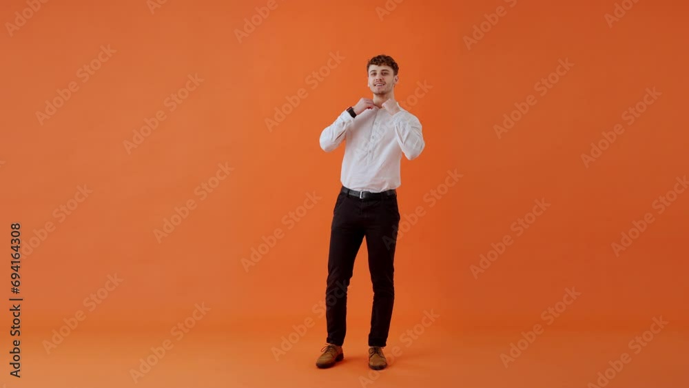 Smiling guy spinning in place and changing clothes indoors Smiling guy spinning in place and changing clothes indoors