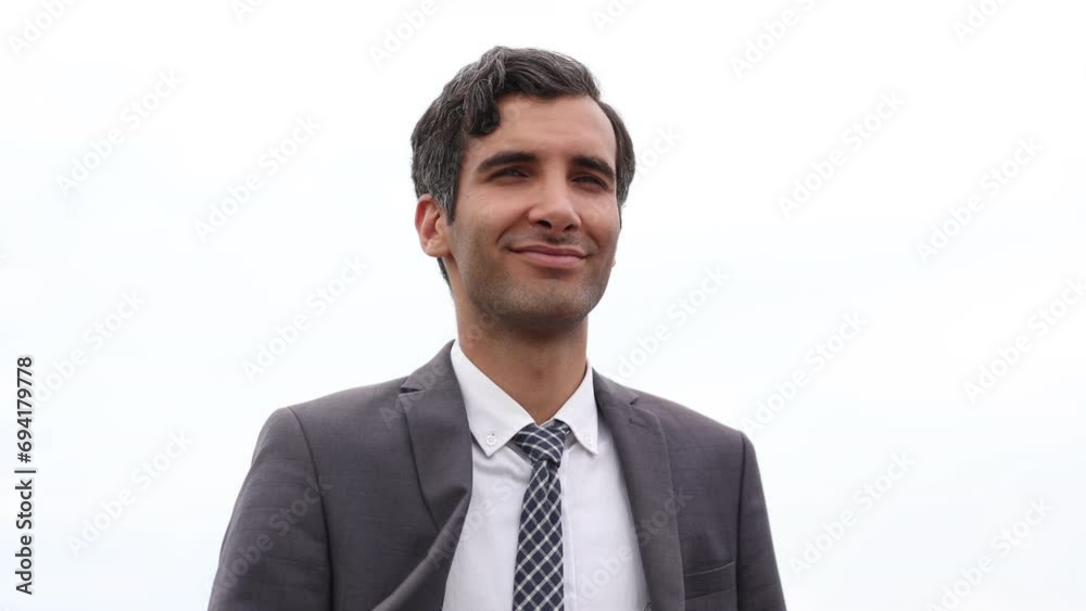 Handsome businessman looking satisfied, smiling a standing over white background