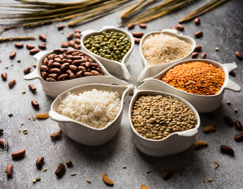 Indian Beans Pulses Lentils Rice and Wheat grain in a white Sunburst or sun rays shape designer container   selective focus. 