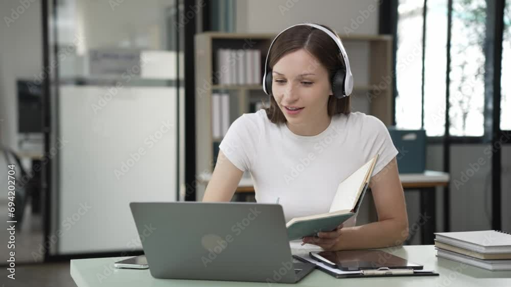 Gen Z young student girl in headphones studying internet at laptop Listen to audio narration Webinars Writing notes, listening to podcasts online, woman taking listening training course Gen Z young student girl in headphones studying internet at laptop Listen to audio narration Webinars Writing notes, listening to podcasts online, woman taking listening training course