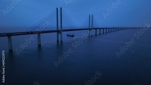 Panoramic Aerial view of Oresund Bridge who is a combined motorway and railway, sea bridge between Denmark and Sweden (Copenhagen and Malmo) and ship - seascape of Baltic Sea, Europe from above photo