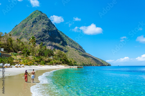 Young couple men and women on vacation in Saint Lucia, luxury holiday Saint Lucia Caribbean, Asian women and Caucasian men on vacation at the tropical Island of Saint Lucia Caribbean photo