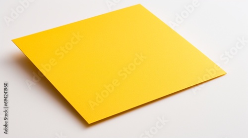A close-up yellow invitation card against a spotless white backdrop, the high-quality image showcasing its bright and cheerful presence.