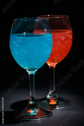 Turquoise and red cocktail on black background