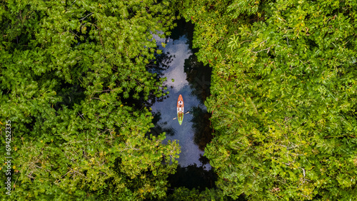 couple in a kayak in the jungle of Krabi Thailand, men and women in a kayak in a tropical jungle in Krabi mangrove forest in Thailand , kayak in magrove photo