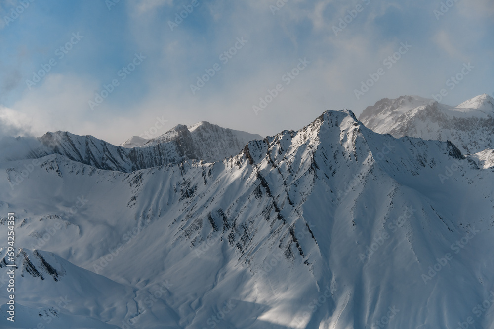 Mountain slopes are partially covered with white snow Mountain slopes are partially covered with white snow
