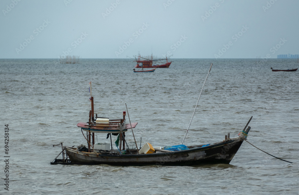 Thai Tradition Wooden Boat floating on the sea Thai Tradition Wooden Boat floating on the sea