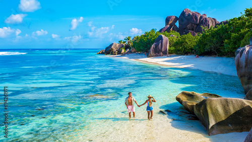 Anse Source d'Argent, La Digue Seychelles, a young couple of men and women on a tropical beach during a luxury vacation in Seychelles. Tropical beach Anse Source d'Argent, La Digue Seychelles photo