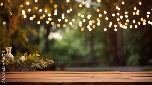 wooden table, with blurred garden background ribbons, garland behind photo